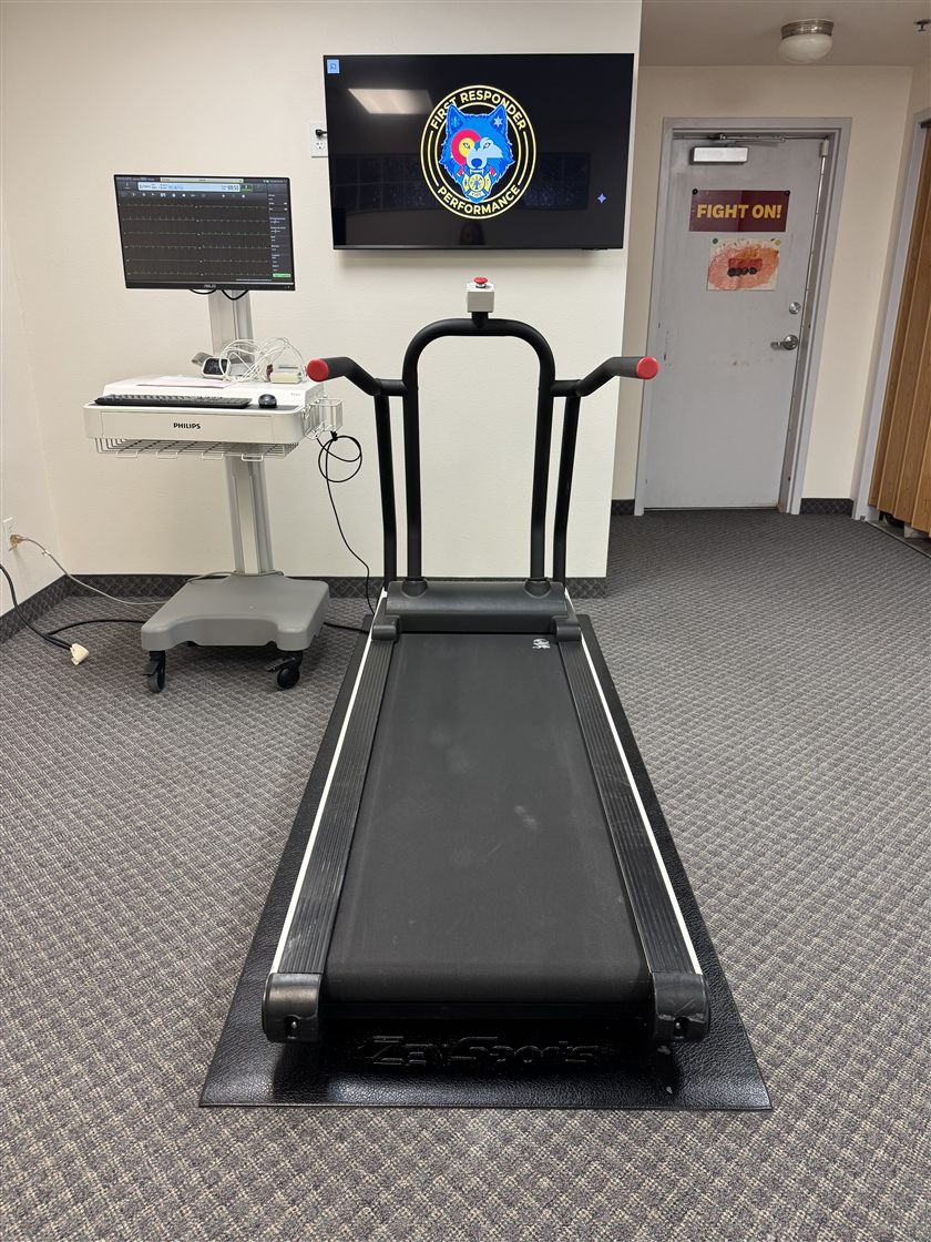 Our testing space — treadmill, ECG equipment, and First Responder Performance display